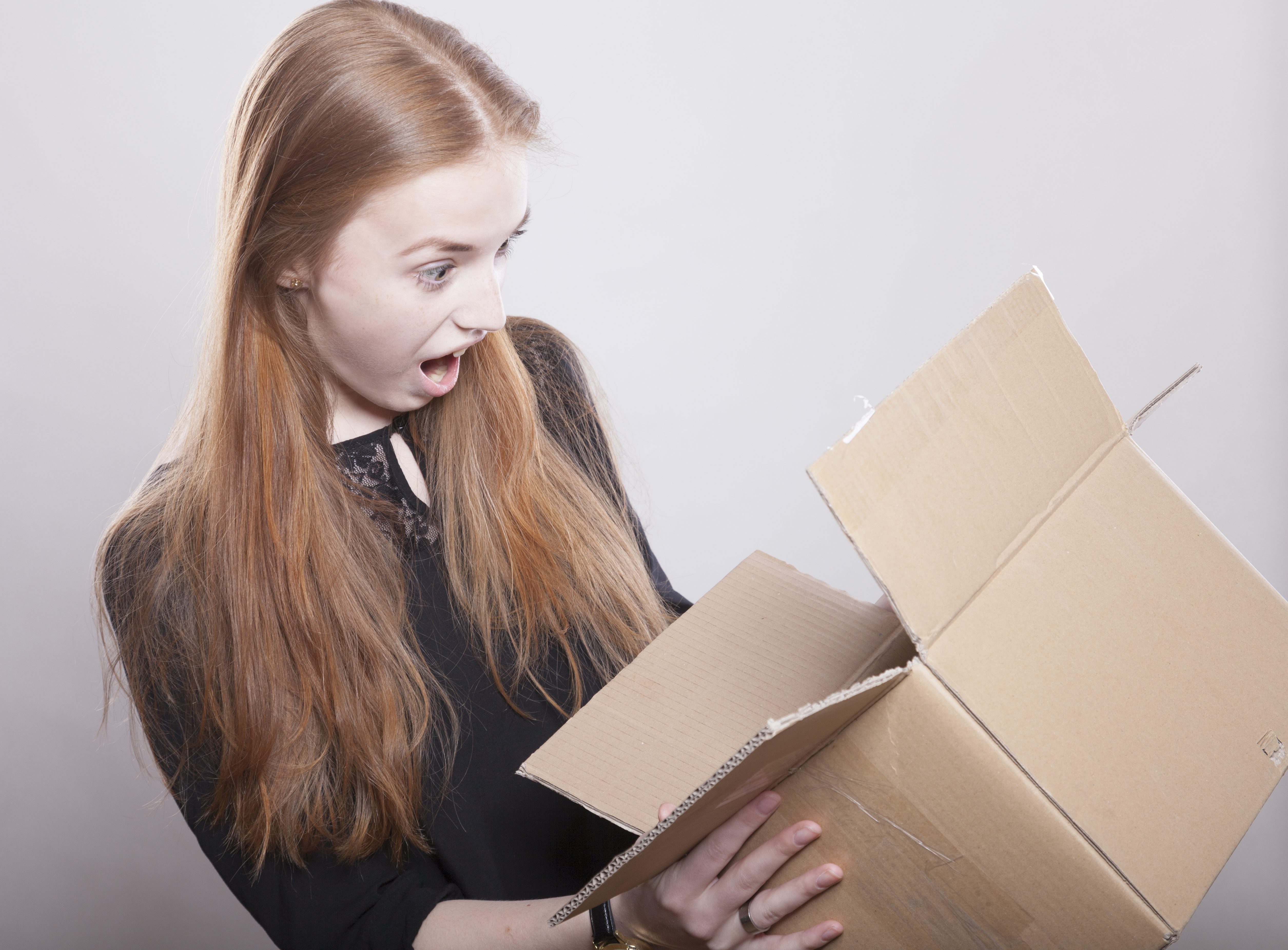 surprised girl opening a box